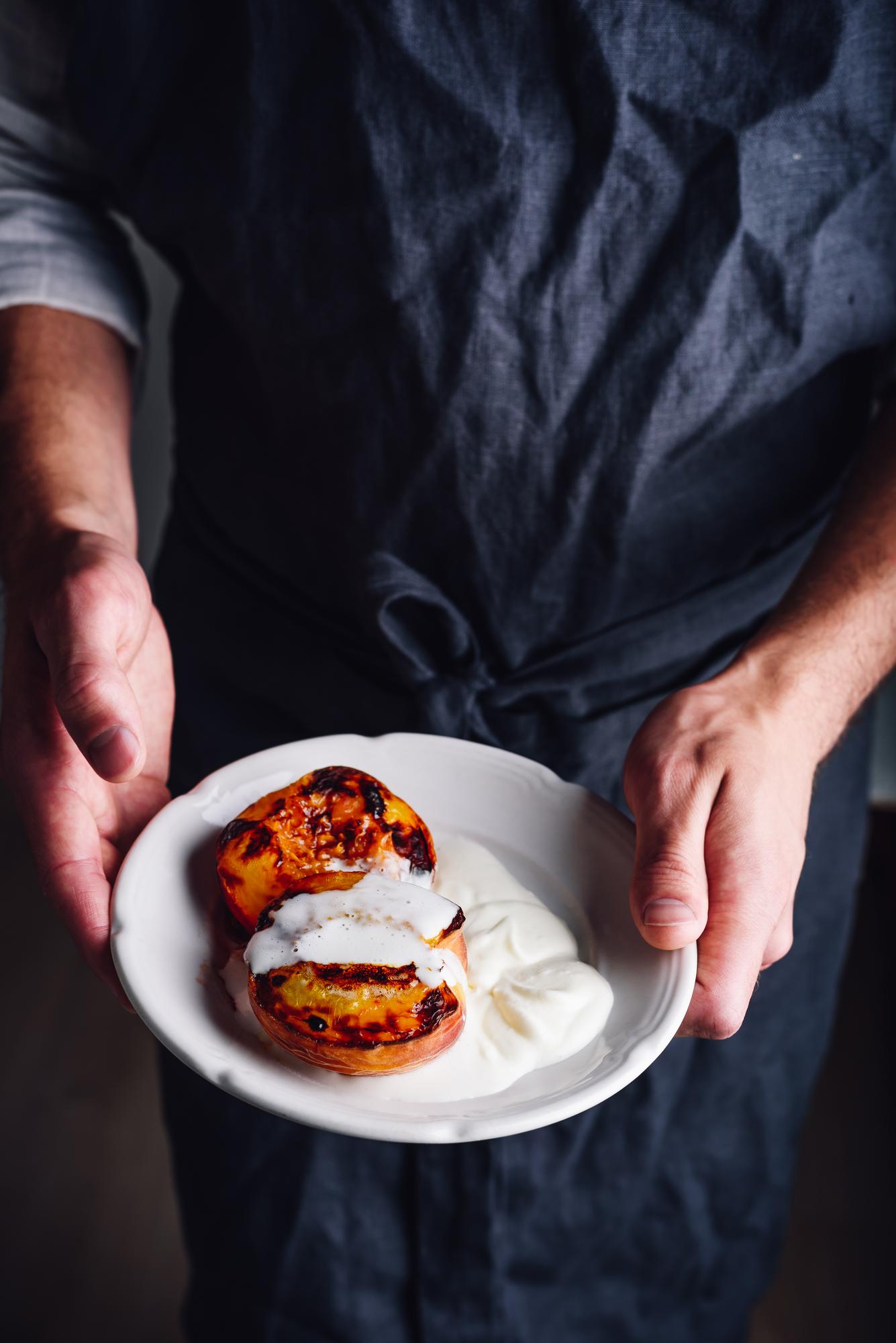 Founder chef arranging a plated dish in a calm studio